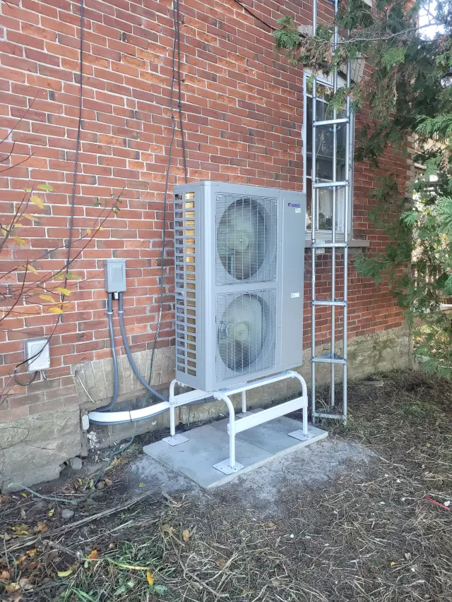 A Denoco outdoor HVAC or heat pump unit on a job site