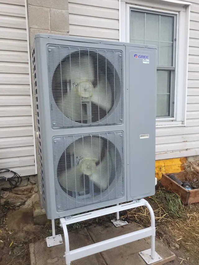 A Denoco outdoor HVAC or heat pump unit on a job site