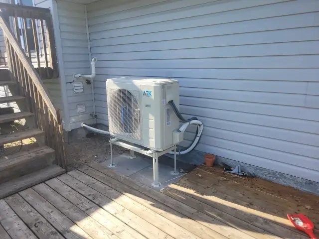 A Denoco outdoor HVAC or heat pump unit on a job site