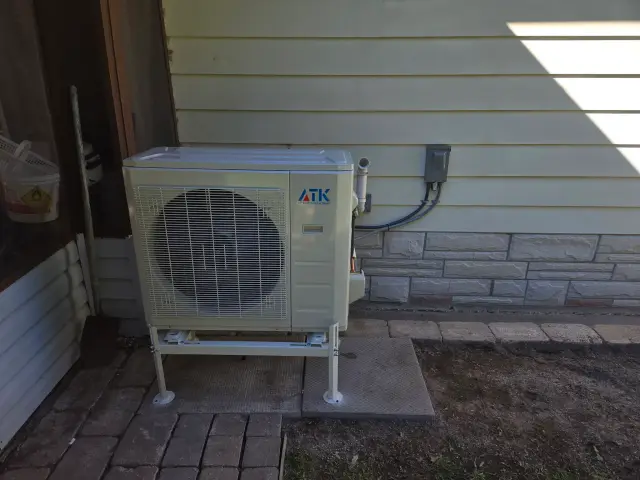 A Denoco outdoor HVAC or heat pump unit on a job site