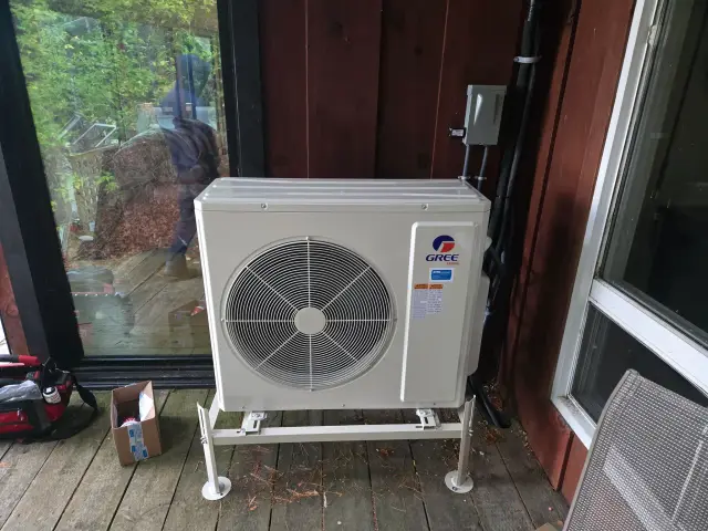 A Denoco outdoor HVAC or heat pump unit on a job site