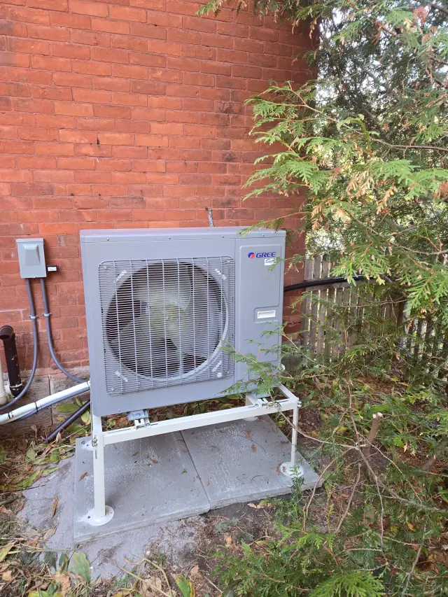 A Denoco outdoor HVAC or heat pump unit on a job site
