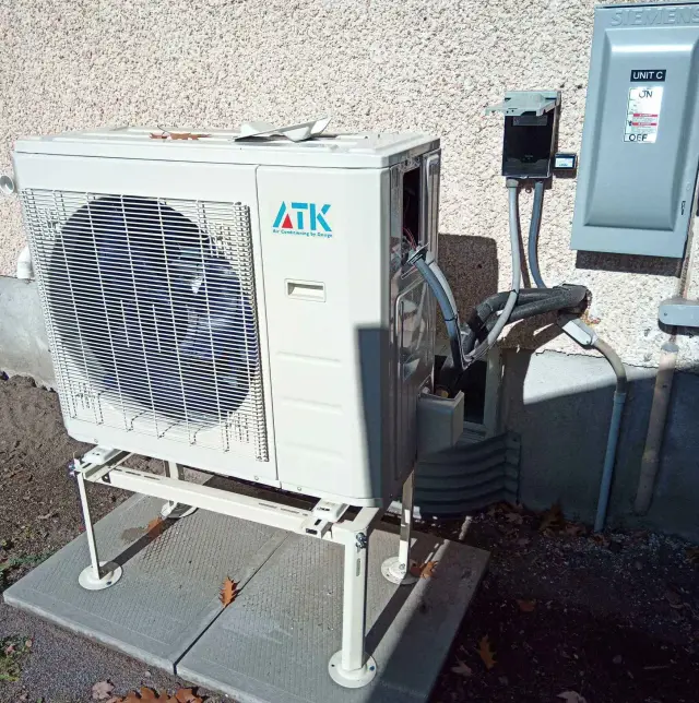 A Denoco outdoor HVAC or heat pump unit on a job site