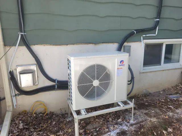 A Denoco outdoor HVAC or heat pump unit on a job site