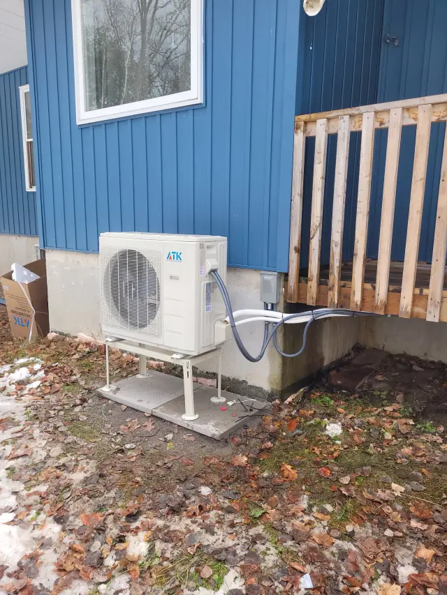 A Denoco outdoor HVAC or heat pump unit on a job site