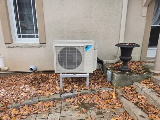 A Denoco outdoor HVAC or heat pump unit on a job site