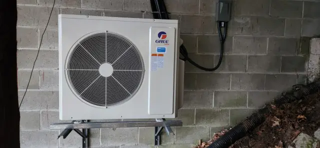 A Denoco outdoor HVAC or heat pump unit on a job site