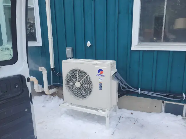 A Denoco outdoor HVAC or heat pump unit on a job site
