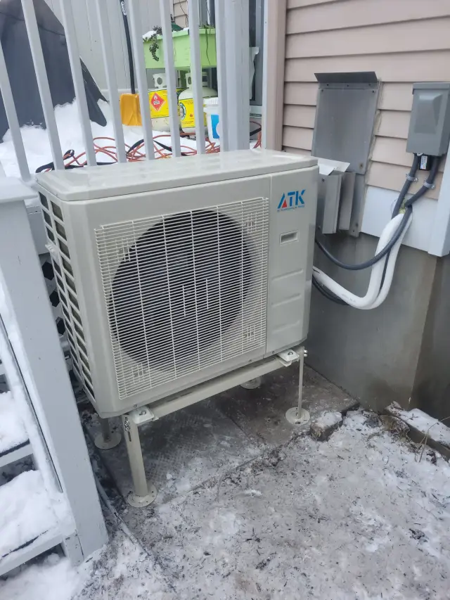 A Denoco outdoor HVAC or heat pump unit on a job site
