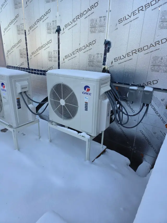 A Denoco outdoor HVAC or heat pump unit on a job site
