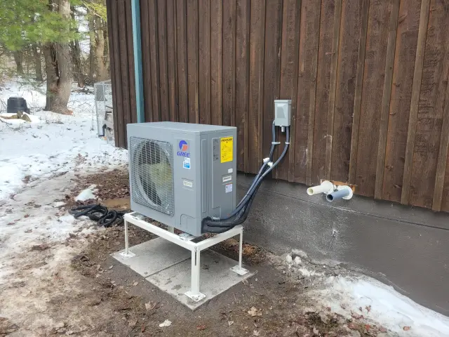 A Denoco outdoor HVAC or heat pump unit on a job site