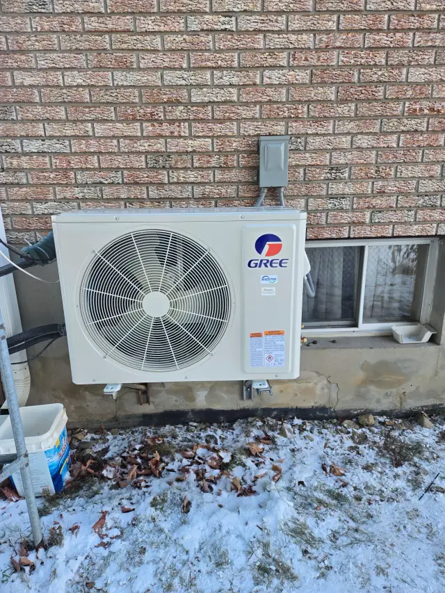 A Denoco outdoor HVAC or heat pump unit on a job site