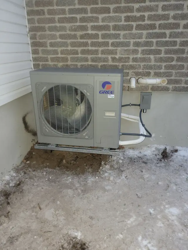 A Denoco outdoor HVAC or heat pump unit on a job site