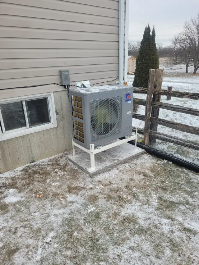 A Denoco outdoor HVAC or heat pump unit on a job site