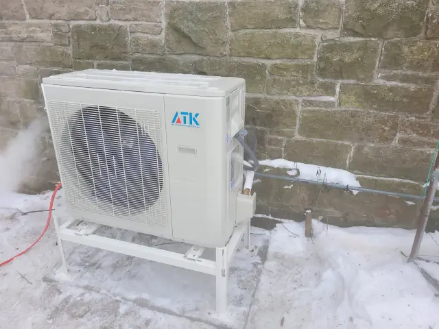 A Denoco outdoor HVAC or heat pump unit on a job site