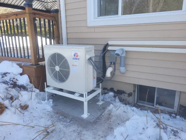A Denoco outdoor HVAC or heat pump unit on a job site