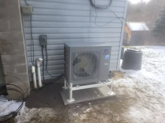 A Denoco outdoor HVAC or heat pump unit on a job site